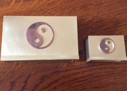 Zwei Hüllen für Streichholzschachteln aus Messing im Yin und Yang Symbol